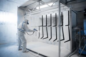 Painter is painting or powder coating parts
