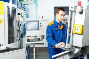 Machinist setting up CNC grinding machine